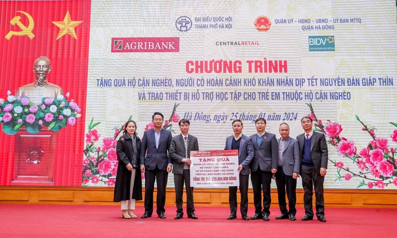 Ông Phạm Đức Ấn - Ủy viên Ban Thường vụ Đảng bộ Khối Doanh nghiệp Trung ương, Bí thư Đảng ủy, Chủ tịch Hội đồng thành viên Agribank trao tặng quà của Agribank hỗ trợ hộ cận nghèo, đối tượng chính sách quận Hà Đông (Hà Nội) nhân dịp Tết Nguyên đán Giáp Thìn