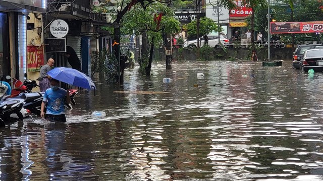 Người Hà Nội bì bõm lội trên các phố sau cơn mưa tháng Năm