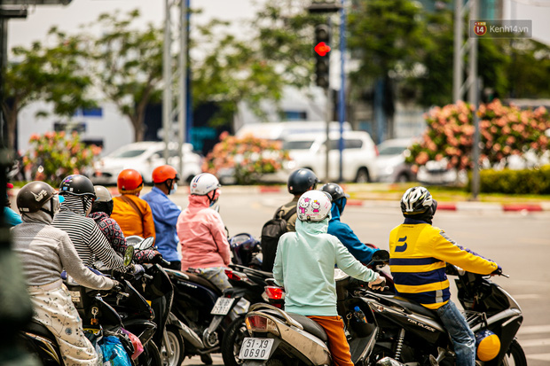 Chùm ảnh: Công nhân vật lộn với cái nóng hầm hập ở Sài Gòn, người đi đường mặc cả áo mưa tránh nắng - Ảnh 1. Chùm ảnh: Công nhân vật lộn với cái nóng hầm hập ở Sài Gòn, người đi đường mặc cả áo mưa tránh nắng - Ảnh 1.
